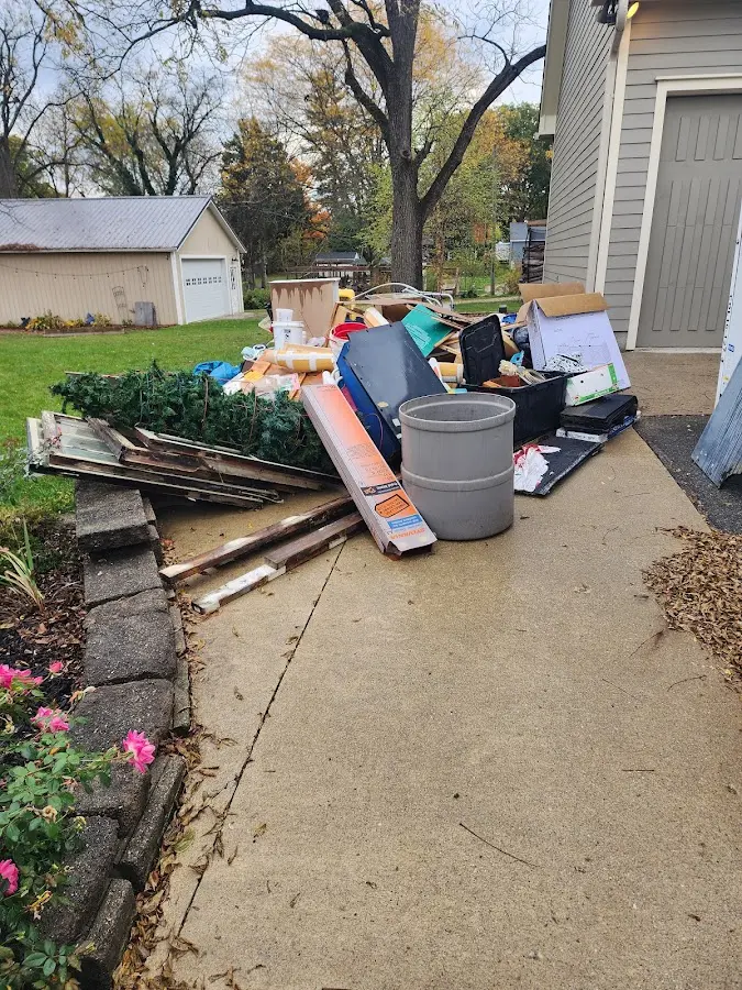 Dumpster being loaded with debris for Commercial Dumpster Rental in Farmingdale